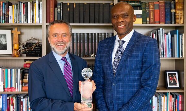 Pres. Corey and Chief Ojeisekhoba pose with Corey's campus safety award