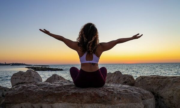 Woman in exercise clothes watching sunset