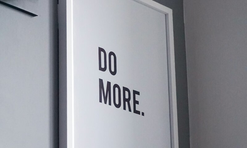 image shows a sign that says "Do More"
