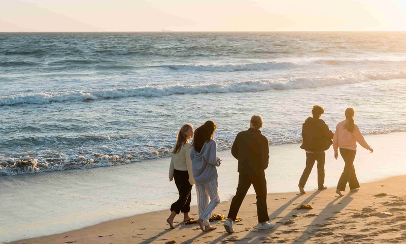 51 students walk together at Huntington Beach