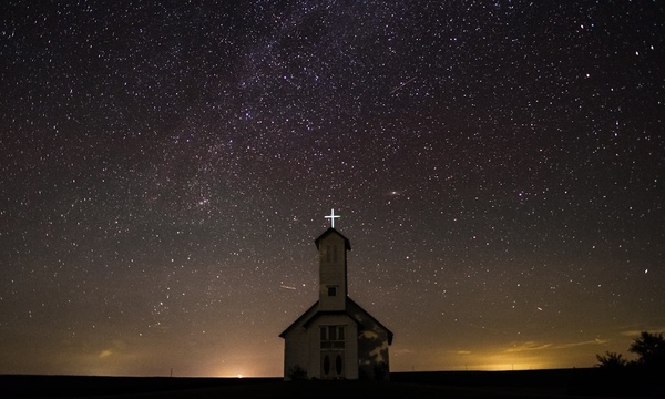 image shows a chapel in front of the night sky