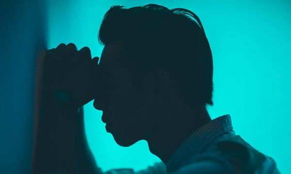 headshot of a man in despair and sorrowful.
