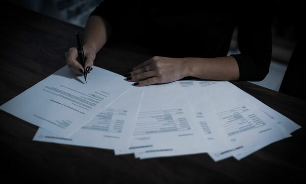 Woman signing contract papers