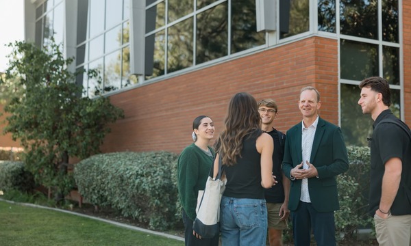 image shows Enete speaking with students