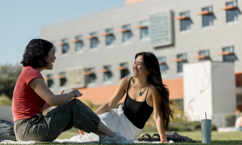 Students sitting and talking on Metzger Lawn