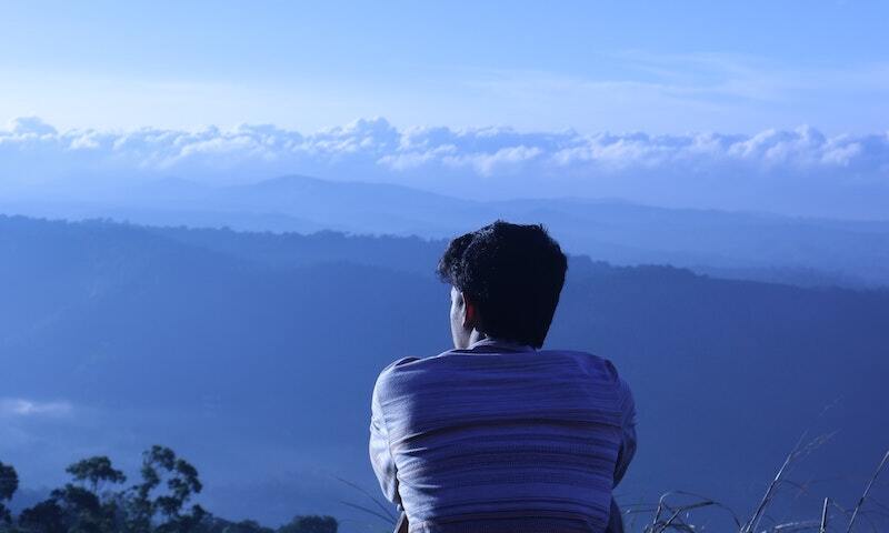 Young man overlooking mountain view 