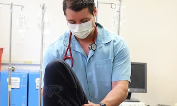 Miguel in a lab coat