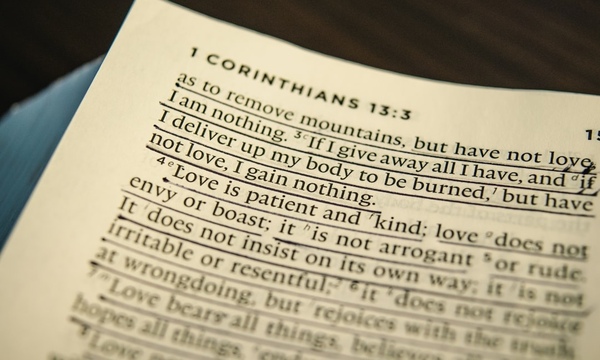 image shows open Bible to 1 Corinthians