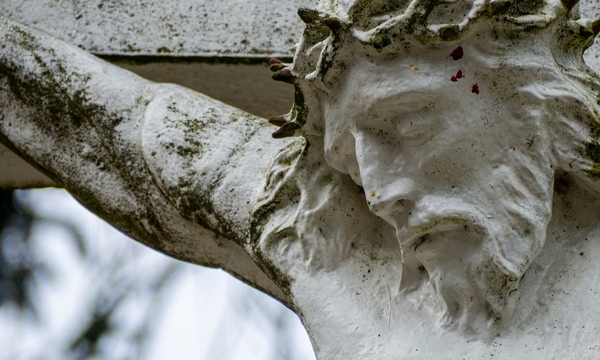 image shows a sculpture of Jesus on the cross 