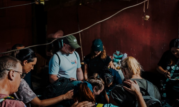 image shows people praying together 