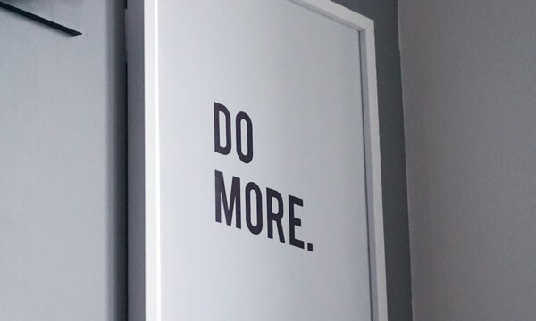 image shows a sign that says "Do More"