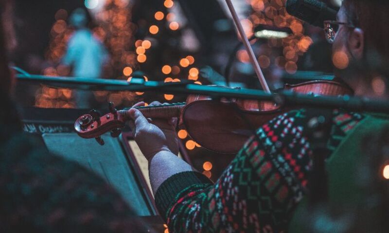 Violinist in Christmas sweater playing in concert