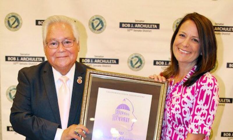Image shows Dr. Sarah Templeton receiving her award from Senator Bob Archuleta