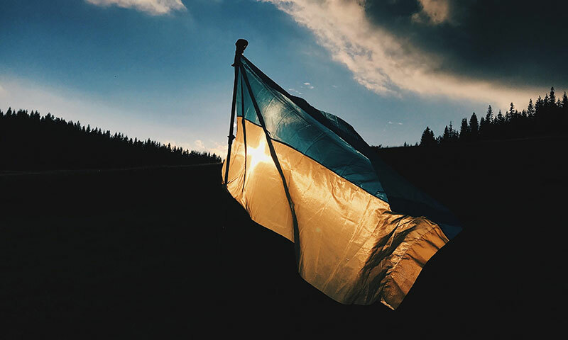Image shows Ukraine flag blowing in the wind