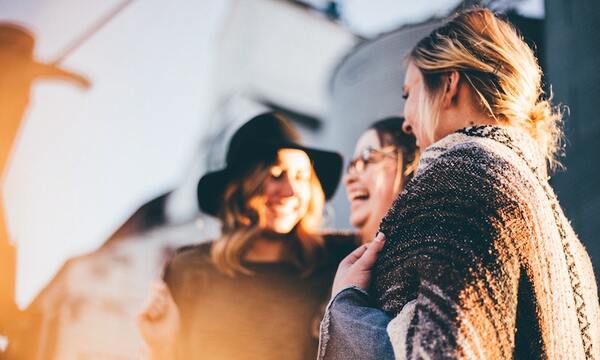 Group of Women Smiling at One Another