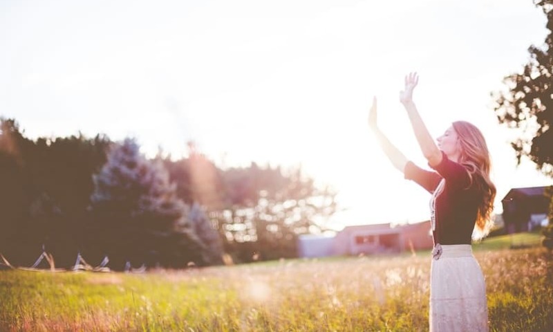 Girl with hands raised