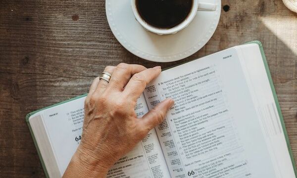 opened bible laying on table 
