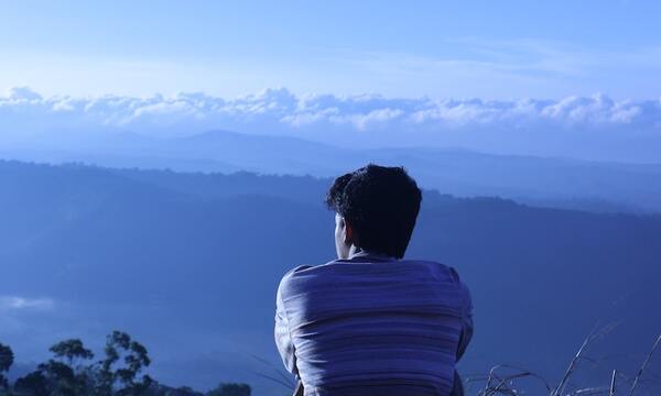 Young man overlooking mountain view