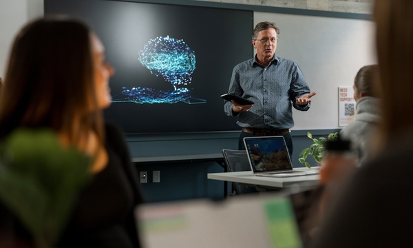 Image shows professor teaching in the AI Lab