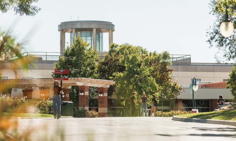 image shows students walking on campus