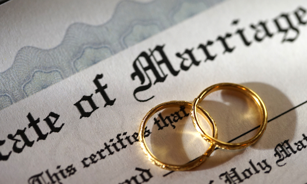 Weddings rings next to marriage certificate