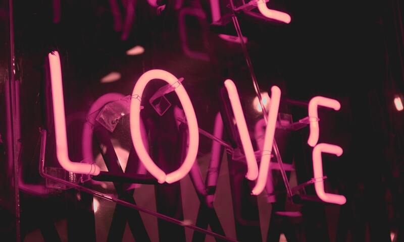 image shows a neon sign that spells love
