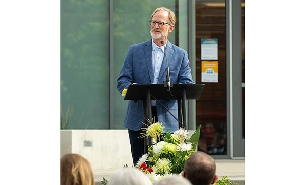 Dan Callis speaking in front of podium