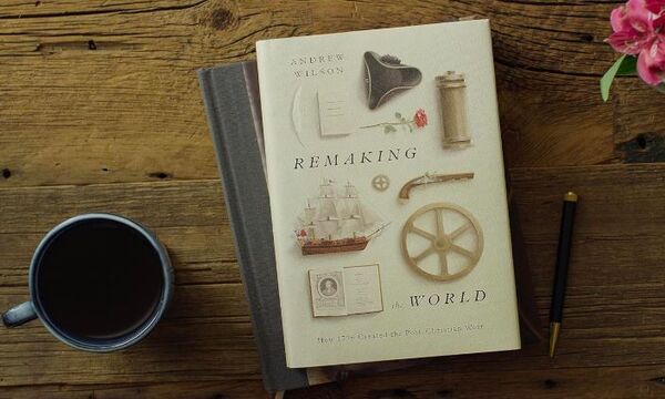 Image shows book cover on desk with coffee mug and pen on display