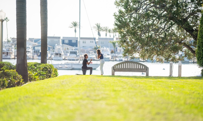 Man proposing to woman at a picnic area near the peninsula