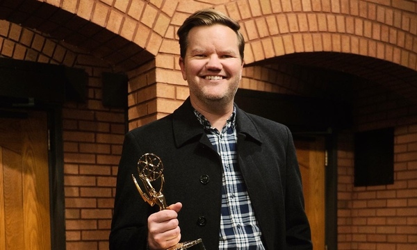 image shows Kevin with the Emmy award