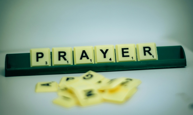 image shows scrabble tiles spelling prayer