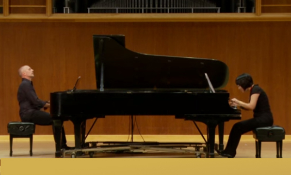 a man and a woman playing pianos