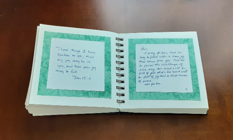 Image shows book created for author by wife with written prayers