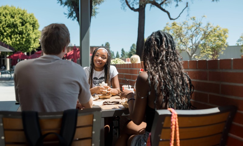 Biola students enjoy food together outside of Eagle's Nest