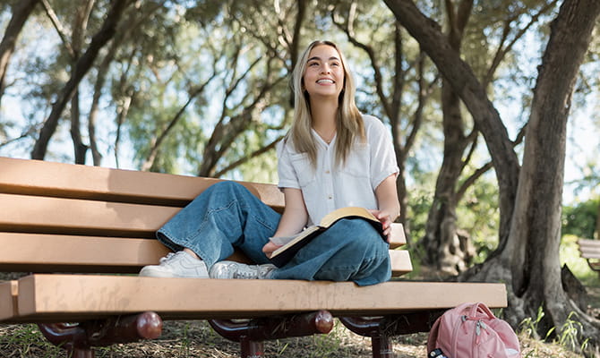 Student sitting on bench outside