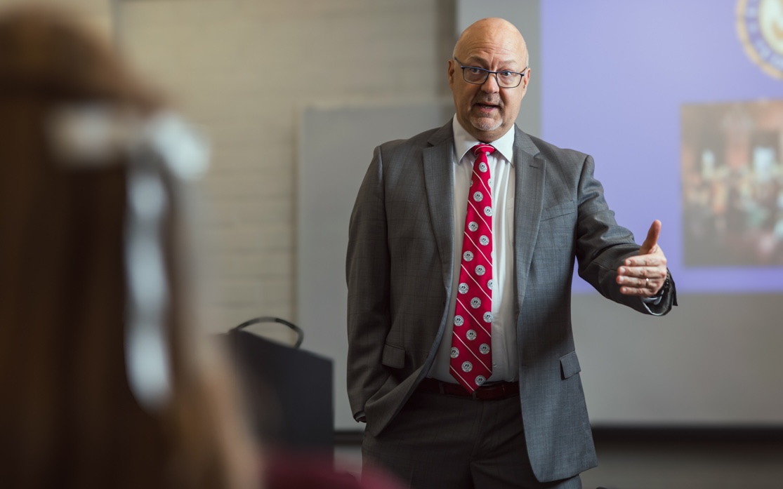 Faculty member speaking to a class of students.