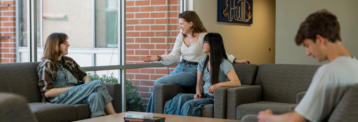 Students in sitting in a residence hall lounge