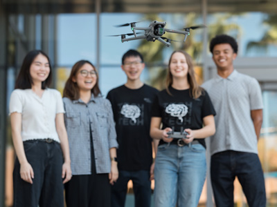 students flying a drone