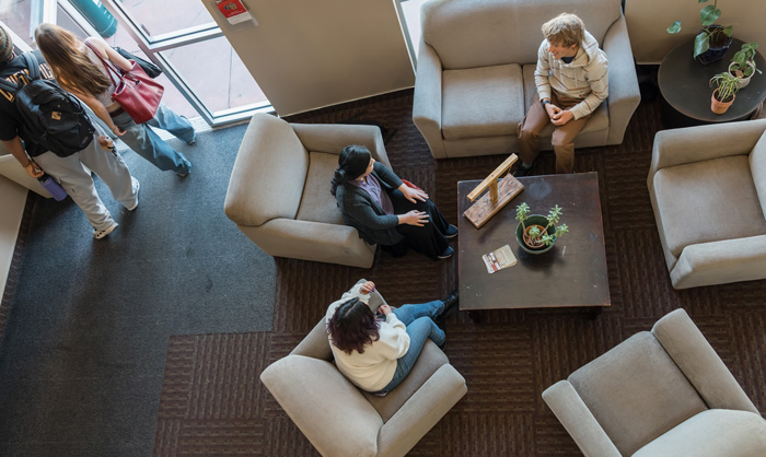 A group of students hang out in a dorm lounge.