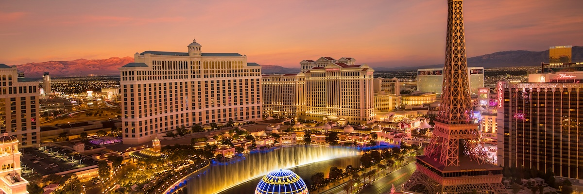 Aerial view of downtown Las Vegas featuring the Eiffel Tower replica and a luxury hotel. 