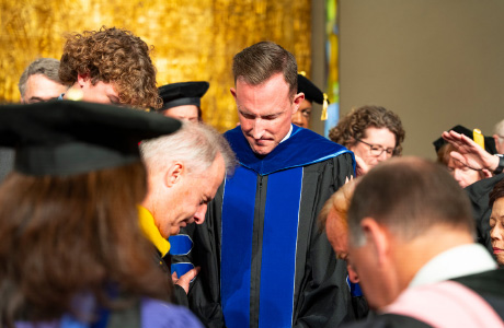 Matthew Hall being prayed for at the installation ceremony.