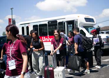 Students getting off the Biola shuttle bus
