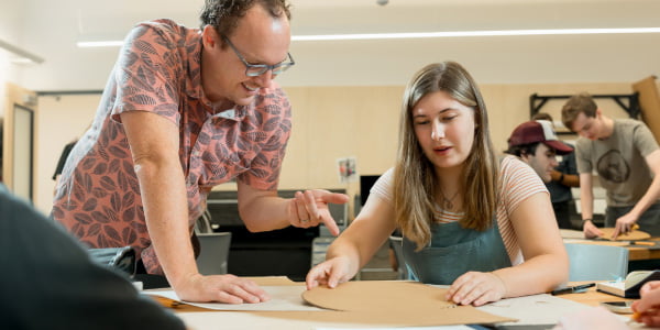 a professor talking with an art student