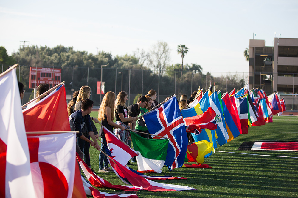 Biola students holding and waving flags.