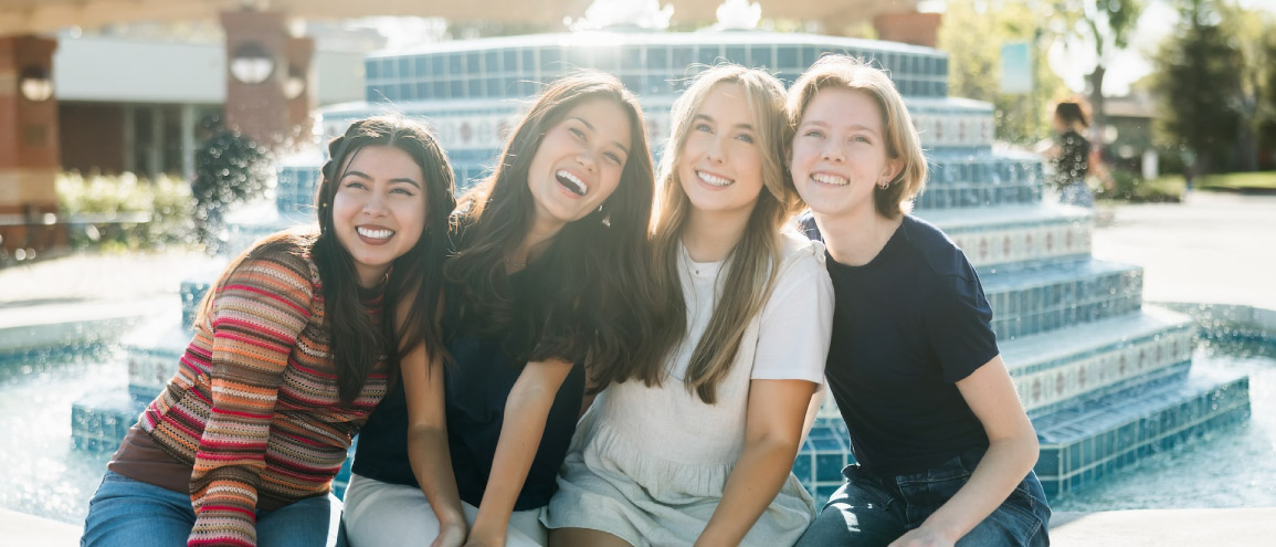 four young people smiling