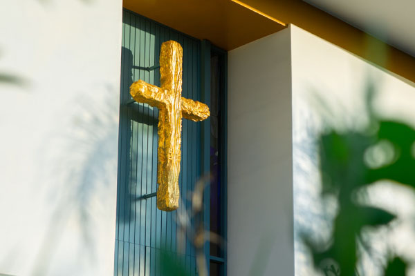 gold cross on the front of a building