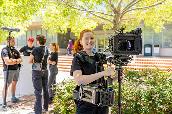 Students working on a project with film equipment