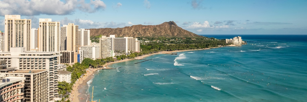 Aerial view of the coast of Hawaii featuring luxury hotels and the beach front.