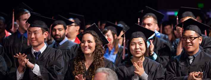 A group of graduates at commencement applaud A group of graduates at commencement applaud