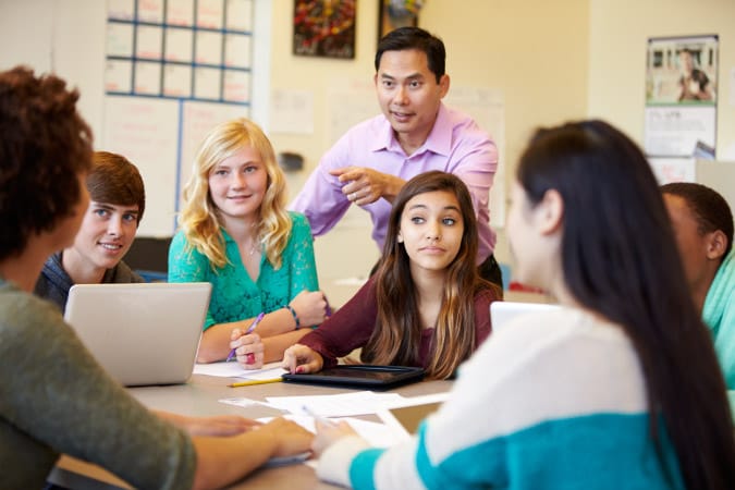 Teacher leading group discussion with students
